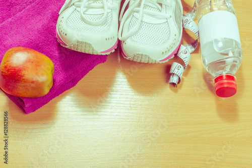 Shoes and sports equipment on wooden floor, top view