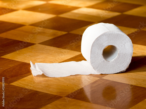 Toilet paper on the wooden floor