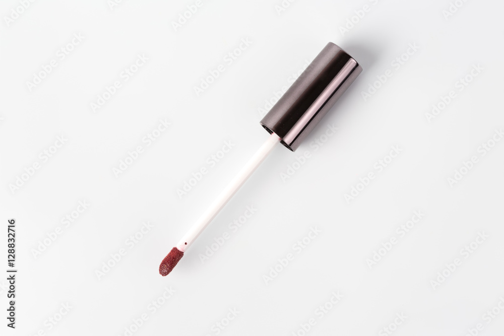 Brush out of lip gloss with red lipstick Brush out of lip gloss with red lipstick