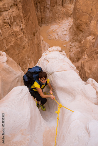 Woman climbing in canyon, Sinai, Egypt