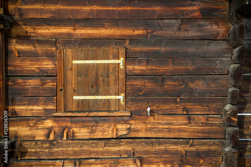 closed window shutter on a sunburned cabin