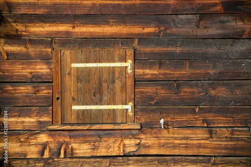 closed window shutter on a sunburned cabin