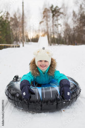 Konstfotografi happy girl riding on a sled on a mountain high