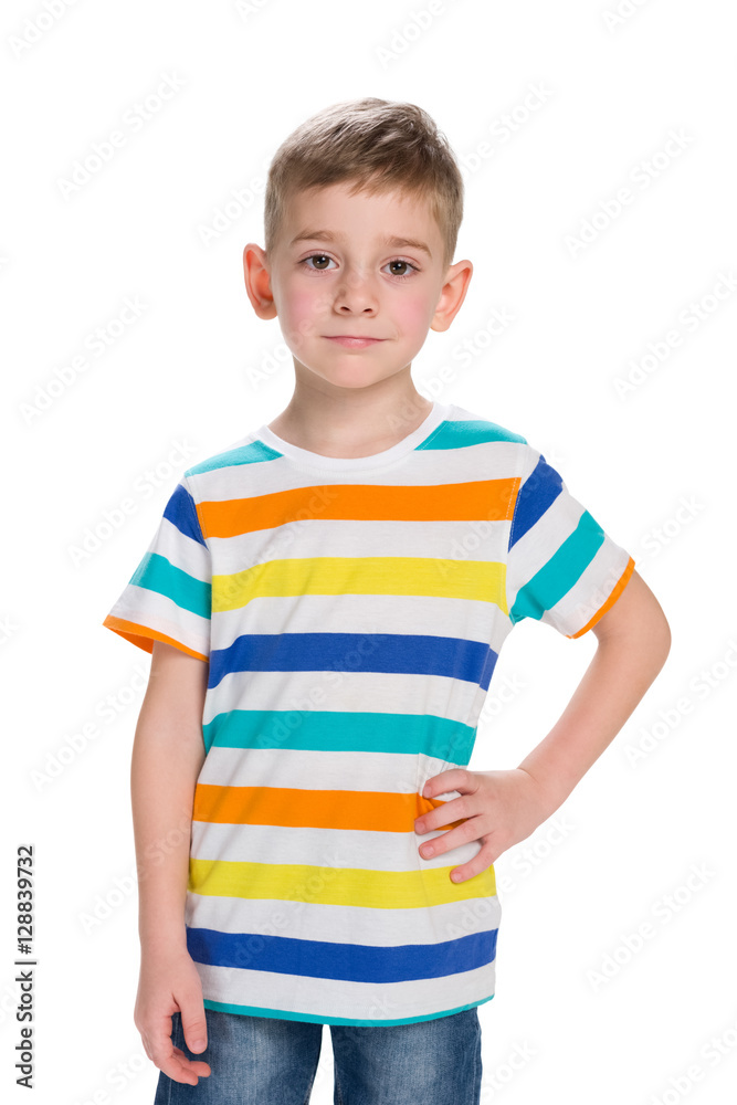 Blond little boy stands against the white Blond little boy stands against the white