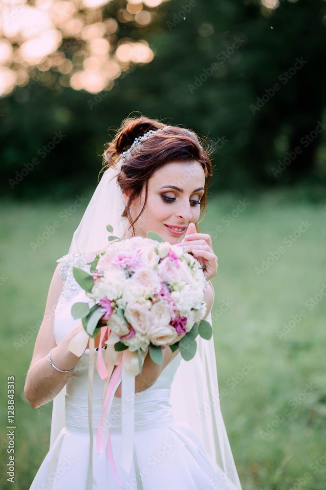 nice portrait of happy and beautiful bride with bouquet of flowe