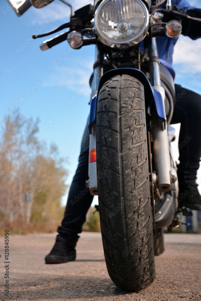 Naklejka premium biker with helmet blue going by a road