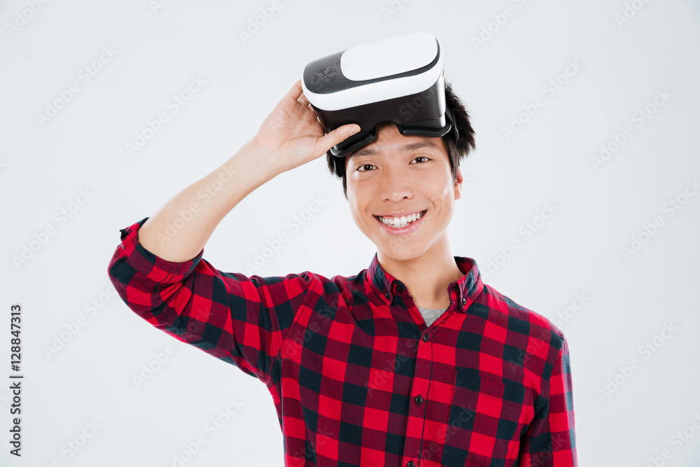 Young asian man wearing virtual reality device Young asian man wearing virtual reality device