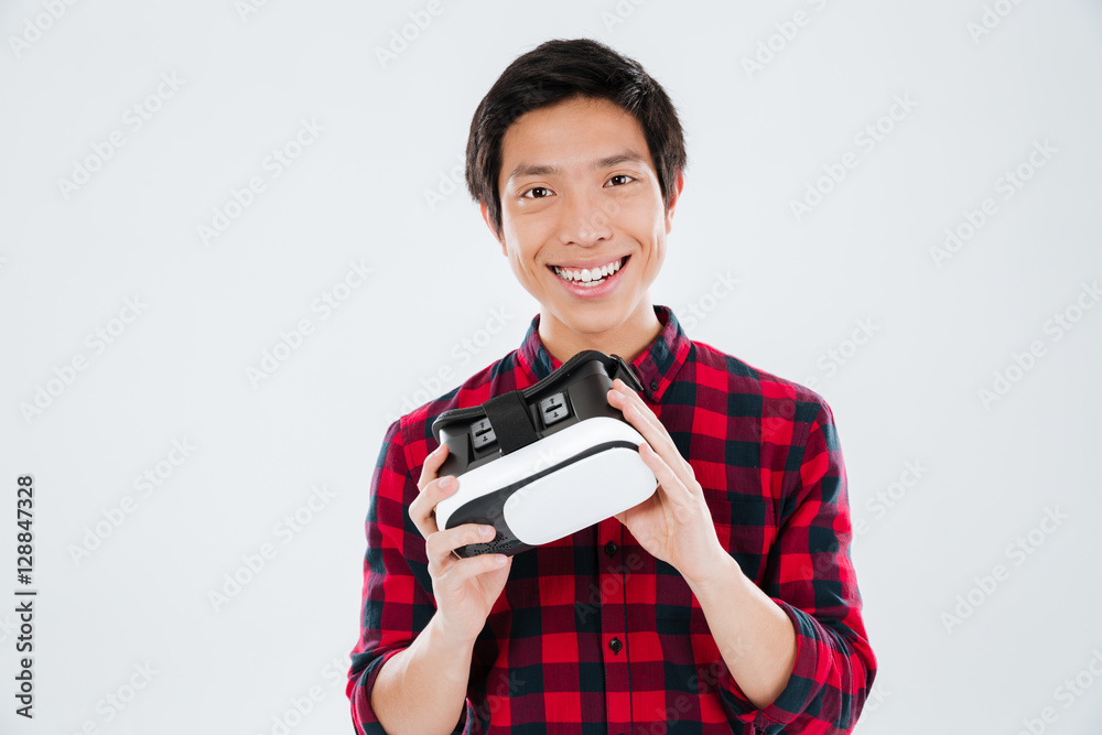 Young man holding virtual reality device Young man holding virtual reality device