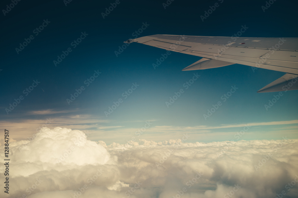 Obraz premium Clouds and sky through window of an aircraft.