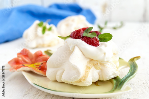 Gentle Air dessert "Anna Pavlova" with raspberries, whipped cream on a light background. Close-up.