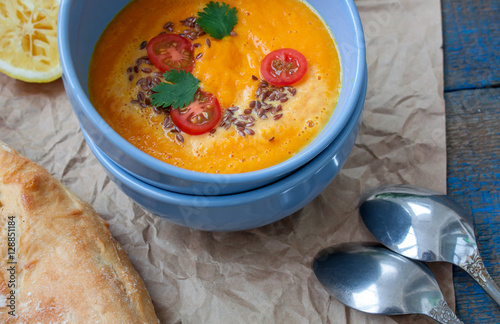 Vegan orange vegetable soup (carrots, sweet potatoes, pumpkin) with herbs and coconut cream. Perfect for the detox diet or just a healthy meal. Love for a healthy raw food concept.