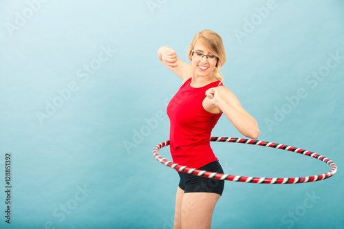 Fitness woman rotates hula hoop © anetlanda