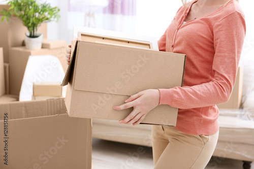 House moving concept. Woman holding cardboard box, closeup