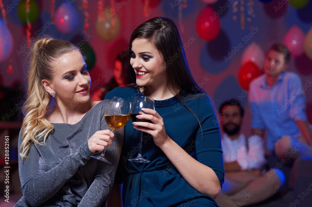 Women holding drinking glass during dance Women holding drinking glass during dance