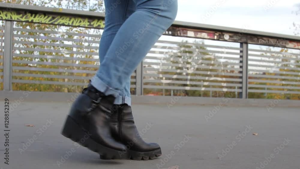 Woman in a hurry in the street of Venice. Female feet walking fast and then starting to run Woman in a hurry in the street of Venice. Female feet walking fast and then starting to run