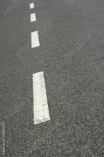 Asphalt road texture with white stripe. Low depth of field