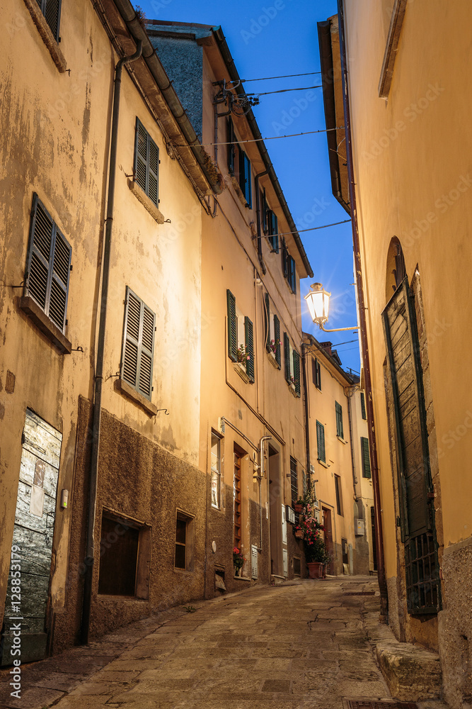 Narrow street in the old town in Italy at night