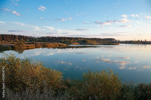 Pond in countryside in autumn at sunset