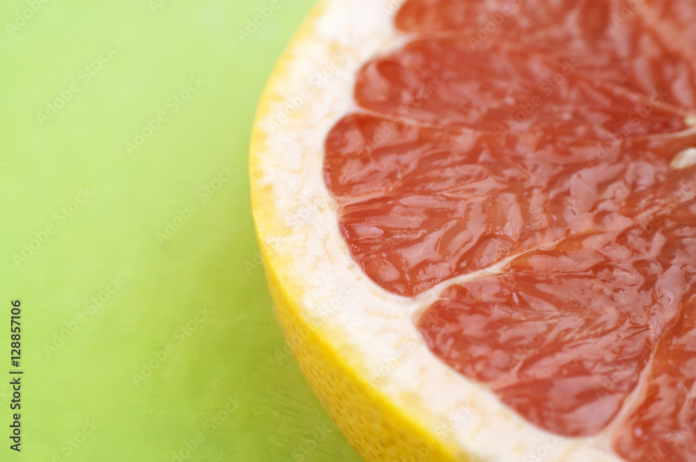 Freshly Sliced Grapefruit On Green Table Freshly Sliced Grapefruit On Green Table