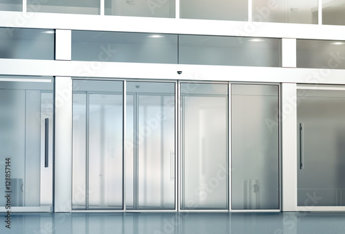 Blank sliding glass doors entrance mockup, 3d rendering. Commercial automatic entry mock up. Office building exterior template. Closed transparent business centre facade, front view.