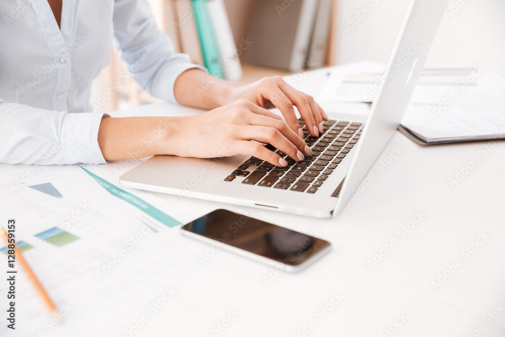 Cropped picture of businesswoman using laptop. Cropped picture of businesswoman using laptop.