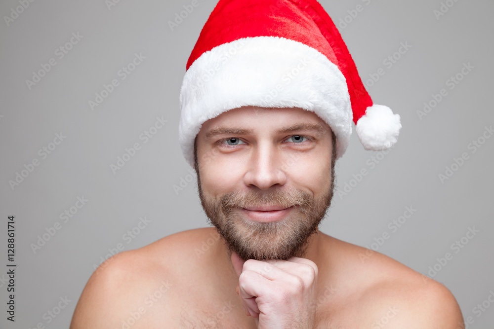 Handsome man with beard wearing a Christmas hat Handsome man with beard wearing a Christmas hat