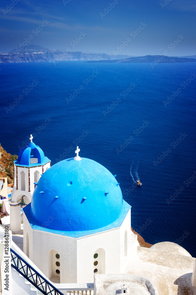 traditional blue dome of church with bellfry against blue sea, Oia, Santorini, retro toned