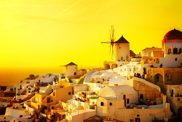 Foto auf Acrylglas Gelb famouse orange sunset of Oia with windmill, Santorini, retro toned  © neirfy