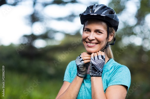 Smiling female athletic wearing bicycle helmet