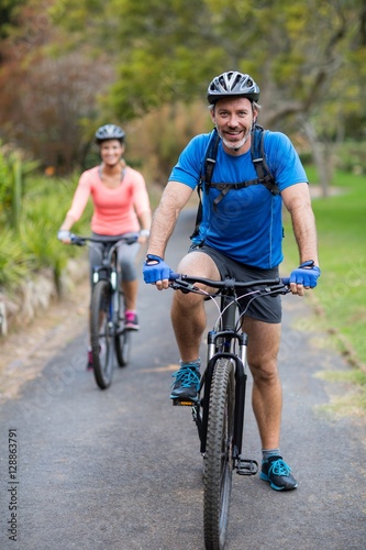 Athletic couple cycling on the road