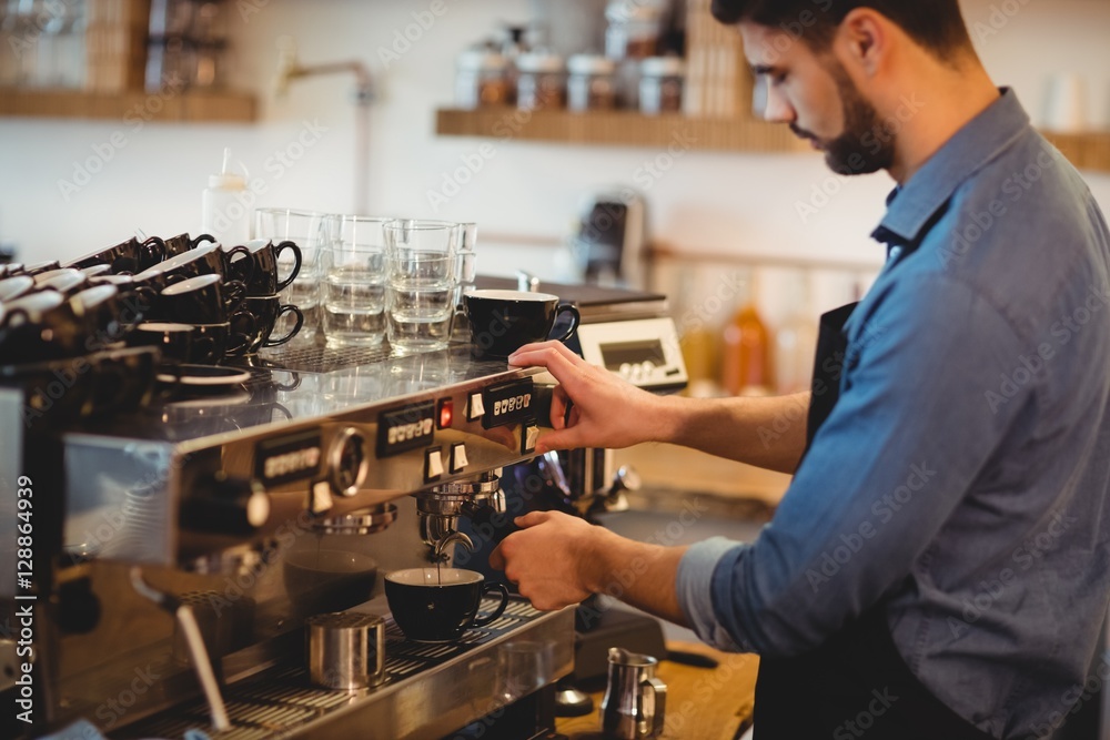 Man taking coffee from espresso machine Man taking coffee from espresso machine