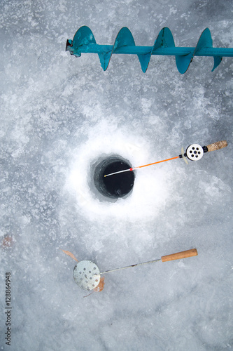 ice screws, shovel, fishing rods, ice fishing near the hole