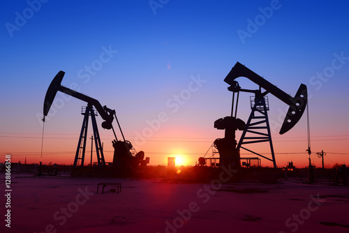 The beam pumping unit is homework, sunset in oil field