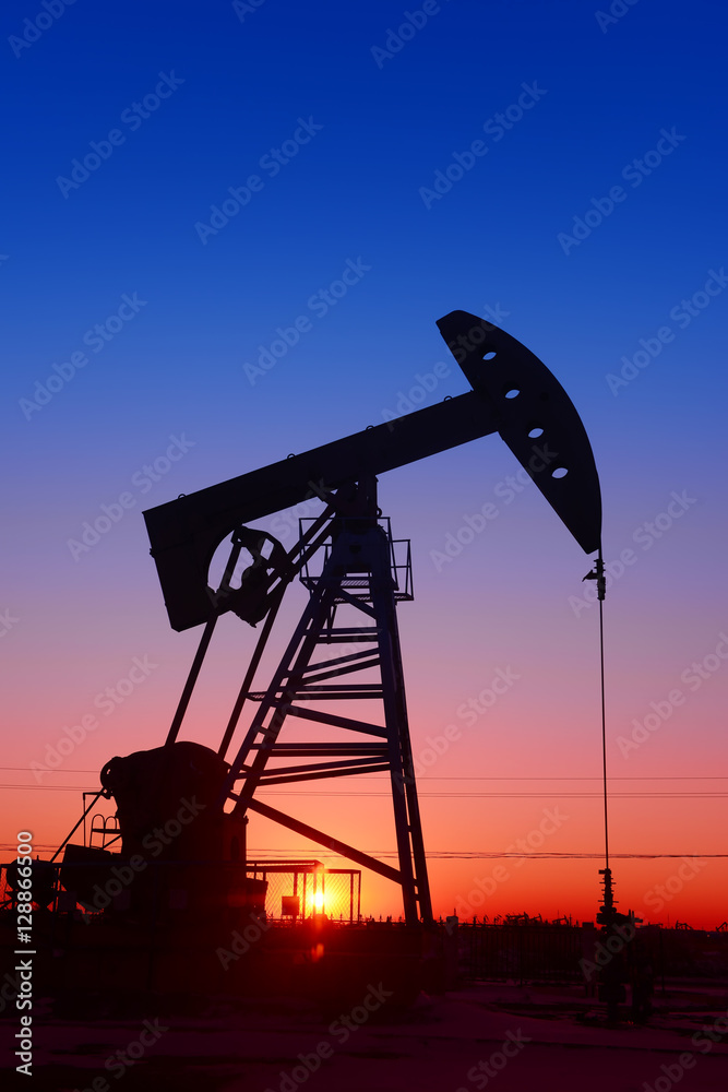 The beam pumping unit is homework, sunset in oil field The beam pumping unit is homework, sunset in oil field