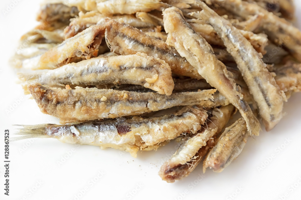 Fried anchovies in the dish, ready to be eaten Fried anchovies in the dish, ready to be eaten
