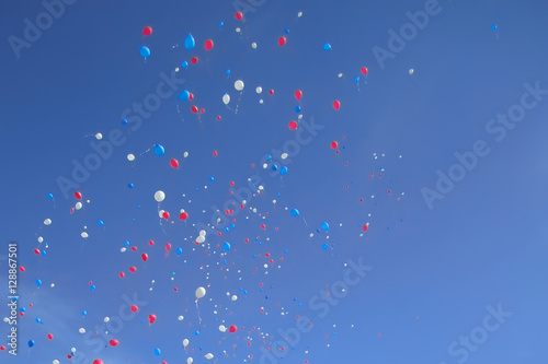 Picture of blue, white and red balloons flying in sky for backgr