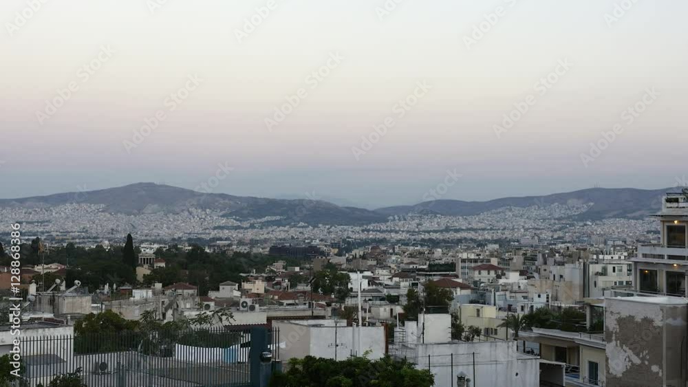 Overview of vast amount of houses in Athens, Greece, at dawn, with mountains on the horizon. Overview of vast amount of houses in Athens, Greece, at dawn, with mountains on the horizon.