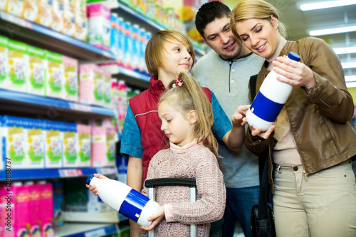 Family of customers with children purchasing milk