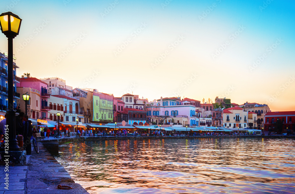embankment and venetian habour with Turkish Mosque Yiali Tzami of Chania at colorful sunset, Crete Greece, retro toned
