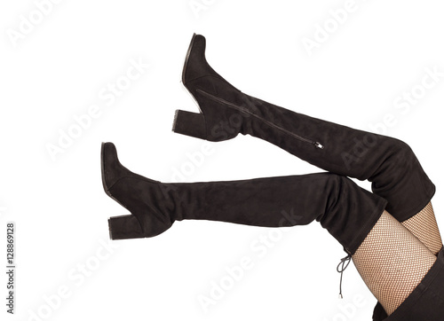 Woman legs in black suede boots on white background
