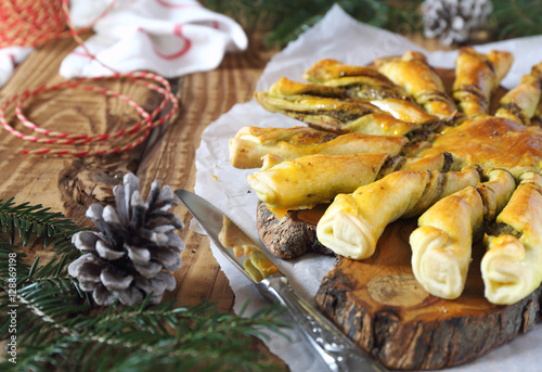 Tarte soleil. New Year  pastry: pesto sun pie and fir branch
