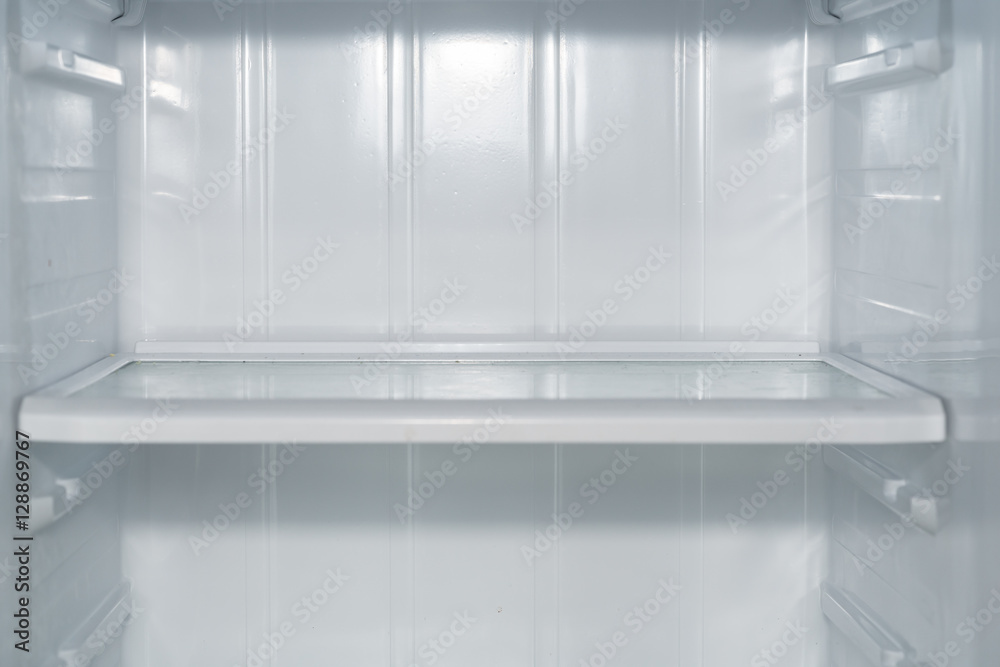 Empty open fridge with shelves, refrigerator.
Empty open fridge with shelves, refrigerator.