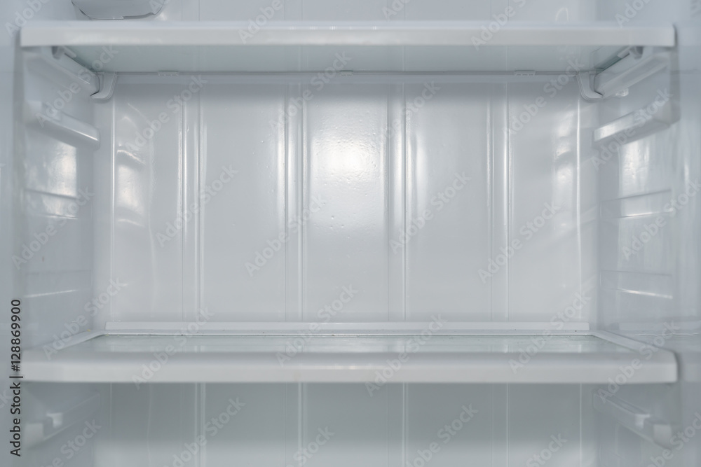 Empty open fridge with shelves, refrigerator.
Empty open fridge with shelves, refrigerator.