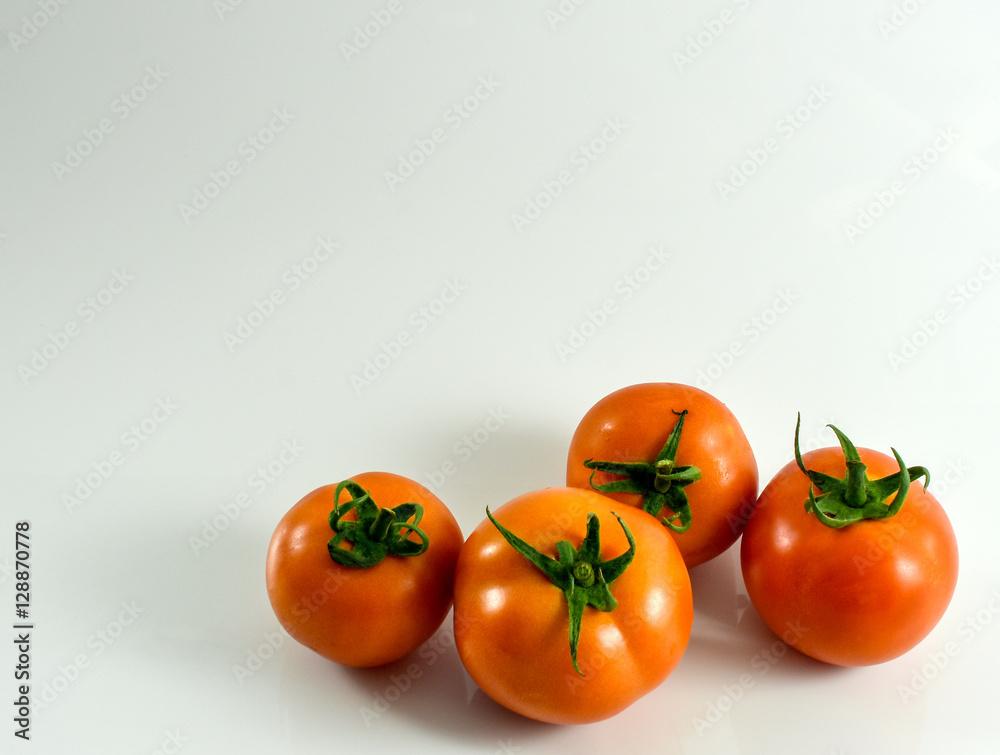 Four fresh tomatoes on white background. Organic vegetable for healthy eating. Four fresh tomatoes on white background. Organic vegetable for healthy eating.