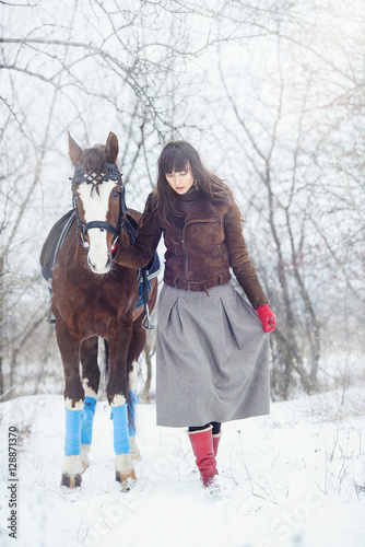 beautiful woman with horse in winter