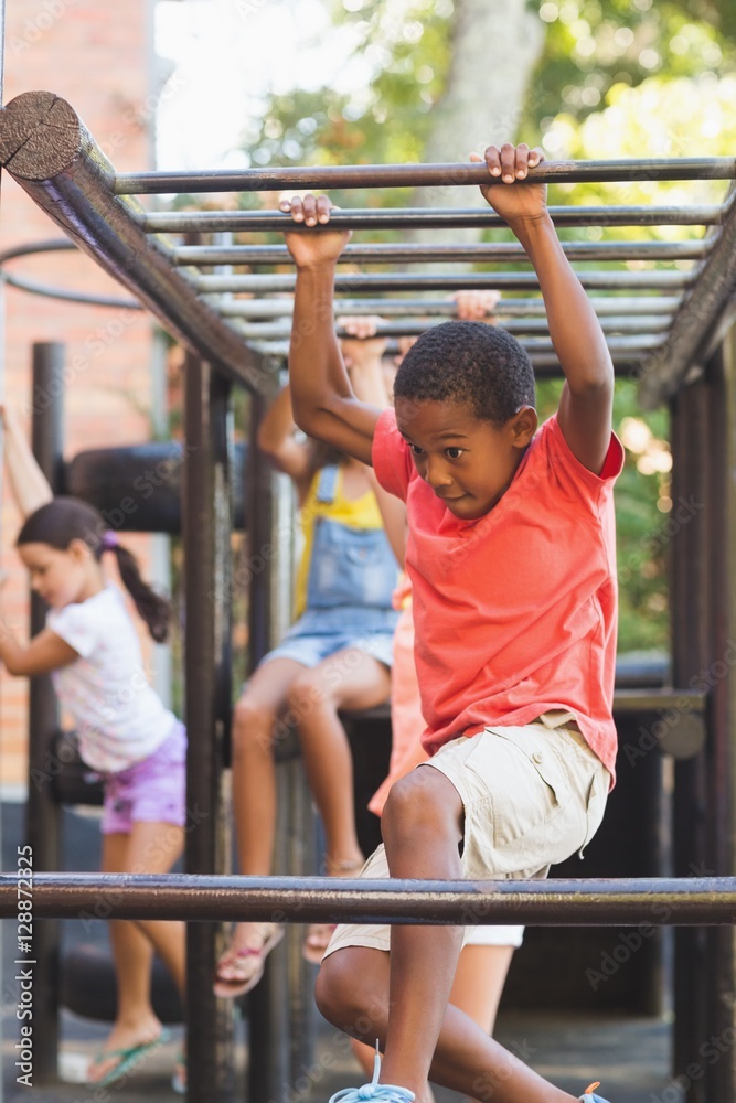 Schoolboy hanging on monkey rack Schoolboy hanging on monkey rack