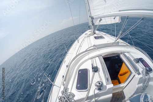 Sailing vessel moving with open sail in the sea