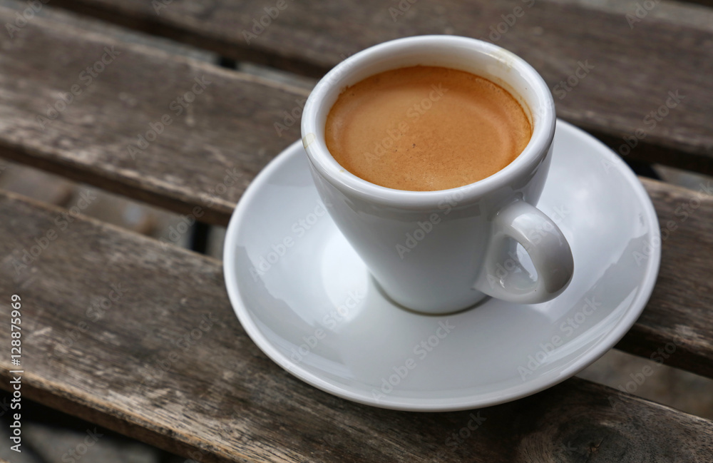 Espresso coffee in white cup close up on table Espresso coffee in white cup close up on table