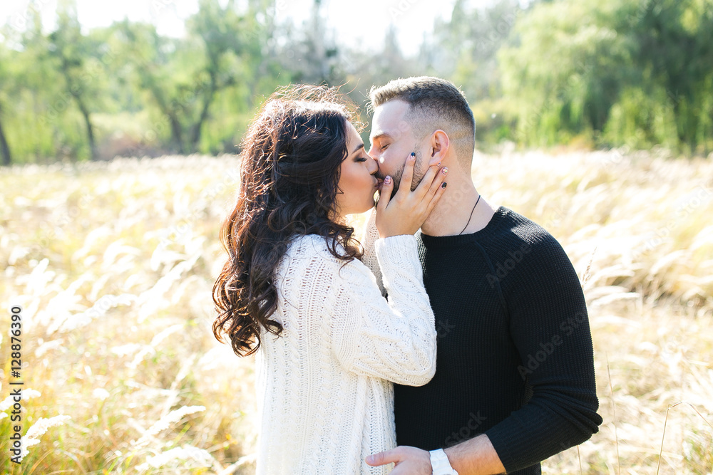 Couple in love - Beginning of a Love Story. A man and a girl on the nature while walking Couple in love - Beginning of a Love Story. A man and a girl on the nature while walking