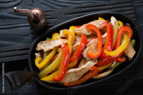 Closeup of fajitas with colorful bell peppers and chicken fillet